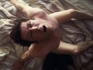 Aidan rests nude in bed before being rudely interr