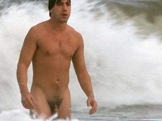 Javier emerges from the ocean totally nude, his nu