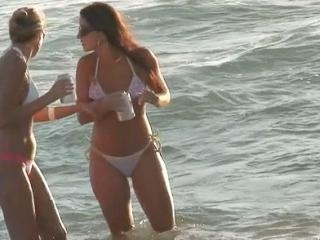 Charming bikini chicks are staying in the water ta